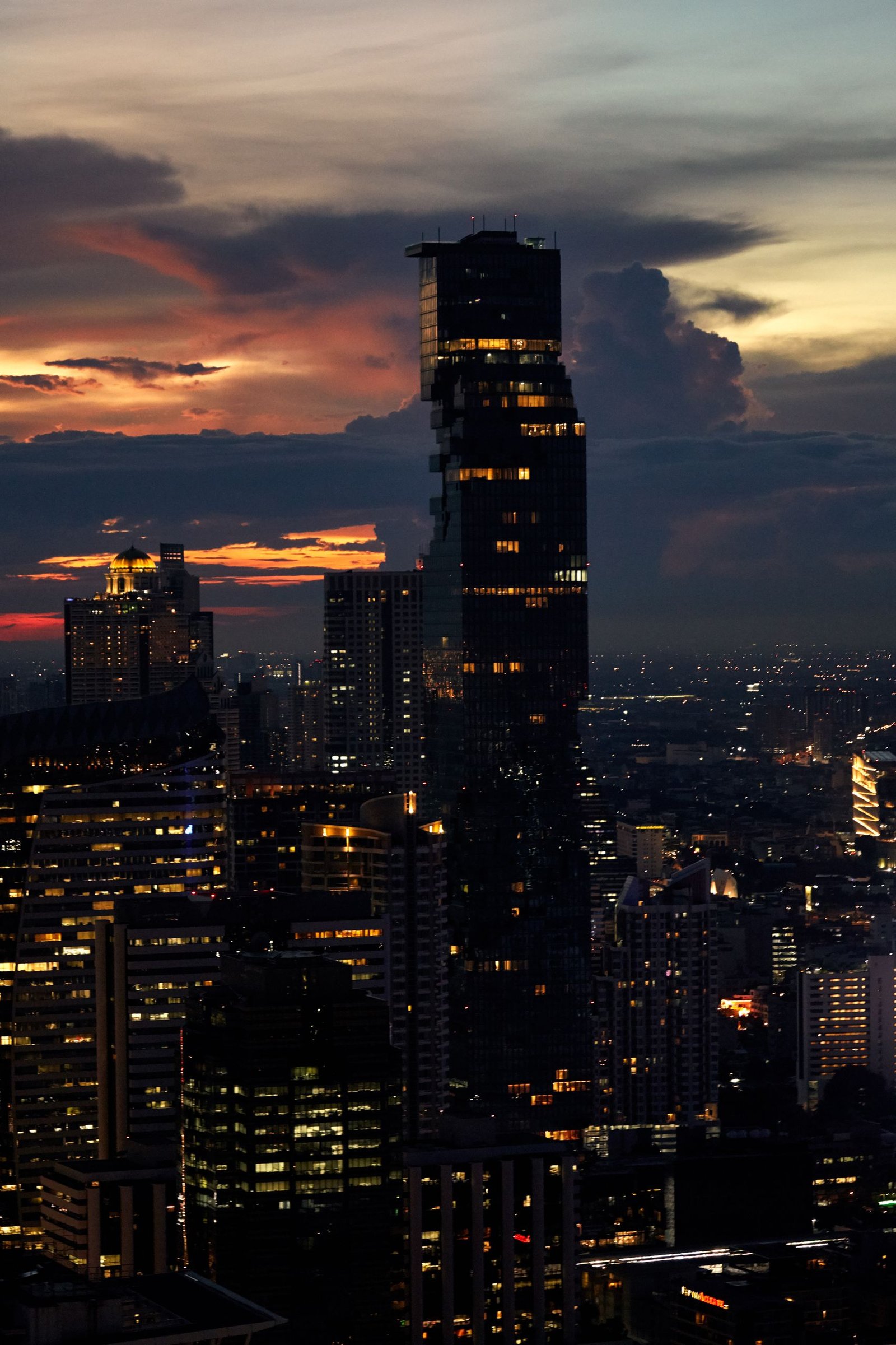 Stunning view of Bangkok's skyline at twilight with the iconic King Power Mahanakhon building.